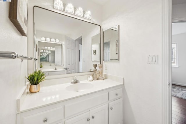 bathroom featuring hardwood / wood-style flooring and vanity