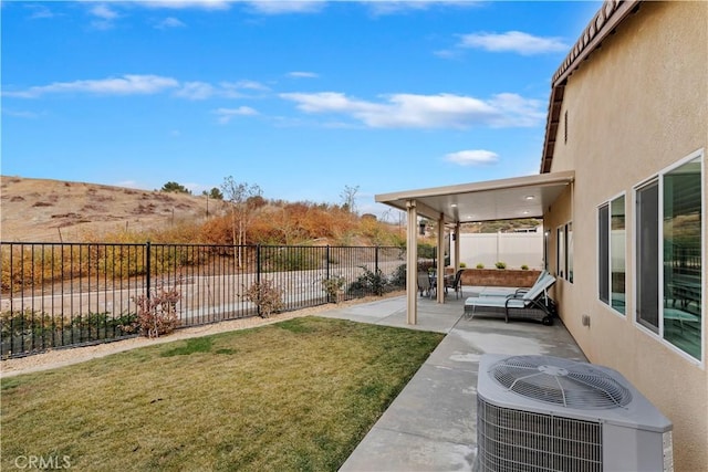 view of yard featuring central AC unit and a patio