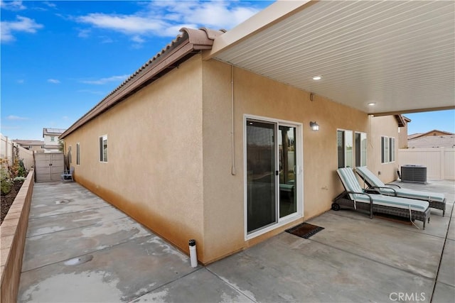 view of home's exterior with a patio and central AC