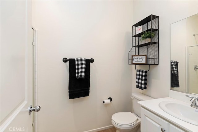 bathroom featuring vanity, toilet, and an enclosed shower