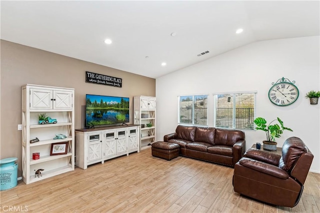 living room featuring vaulted ceiling and light wood-type flooring