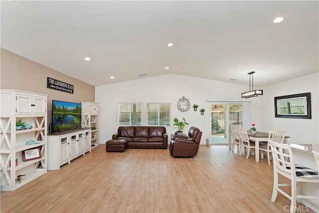 living room featuring vaulted ceiling and light hardwood / wood-style flooring