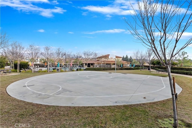 view of basketball court with a yard