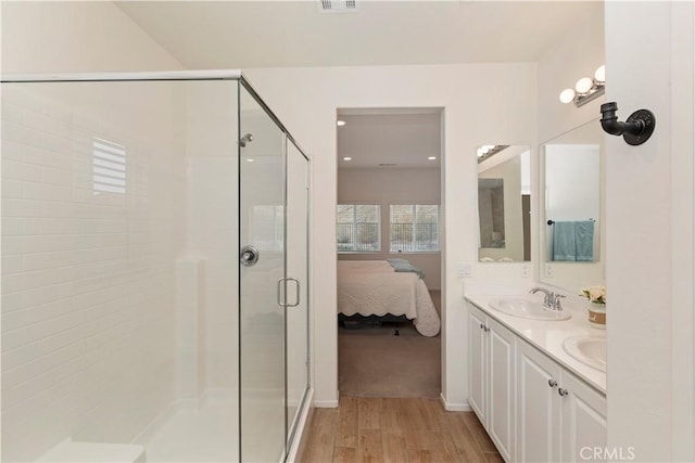 bathroom featuring vanity, a shower with door, and hardwood / wood-style floors