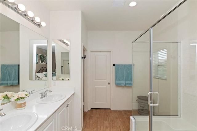 bathroom featuring vanity, hardwood / wood-style floors, and an enclosed shower