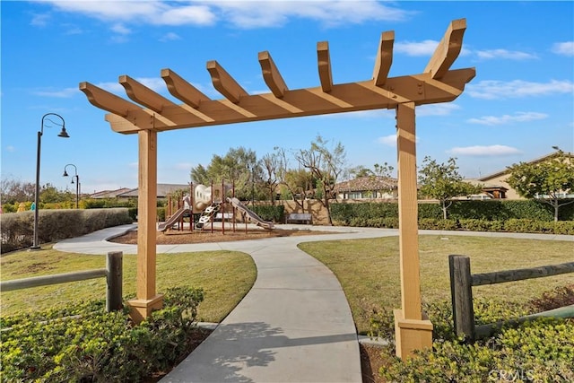 view of home's community featuring a lawn and a playground