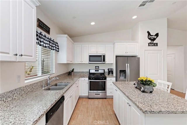 kitchen featuring sink, light stone countertops, white cabinets, and appliances with stainless steel finishes