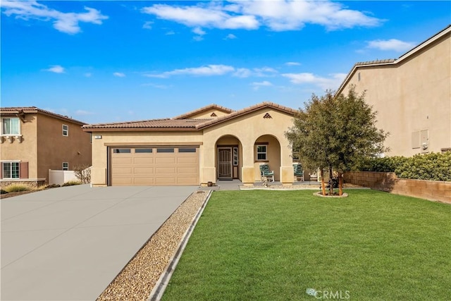 mediterranean / spanish house with a garage and a front yard