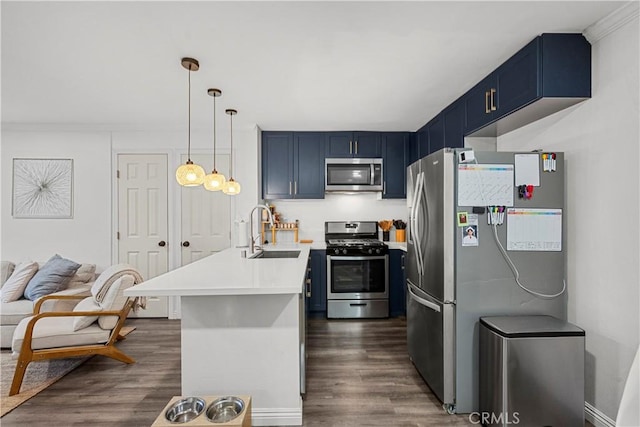 kitchen with stainless steel appliances, blue cabinetry, sink, and dark hardwood / wood-style flooring