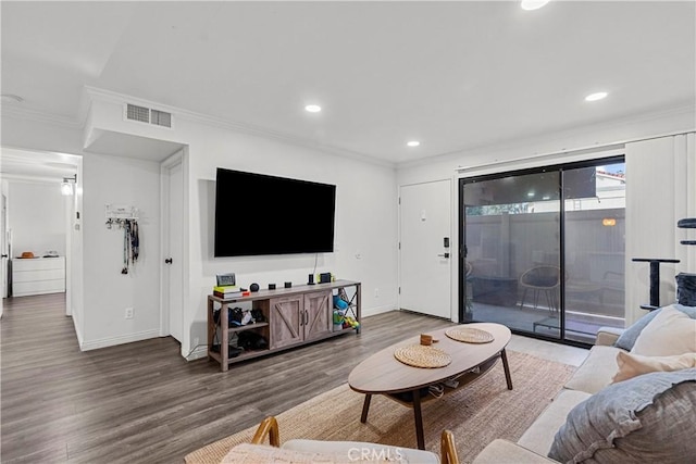 living room with crown molding and hardwood / wood-style floors