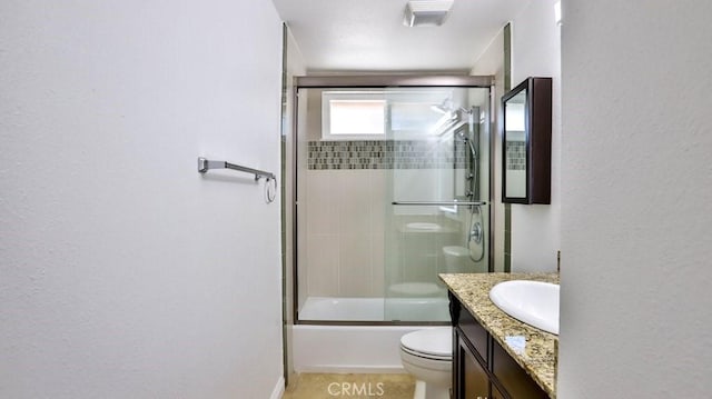 full bathroom with vanity, toilet, and combined bath / shower with glass door