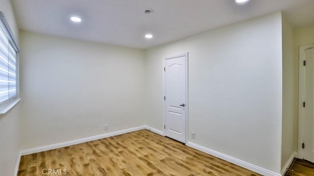 spare room featuring light wood-type flooring