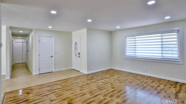 spare room with light hardwood / wood-style flooring