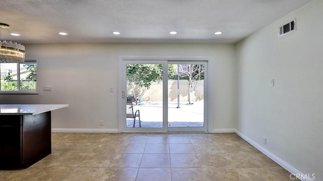 kitchen with plenty of natural light and light tile patterned floors