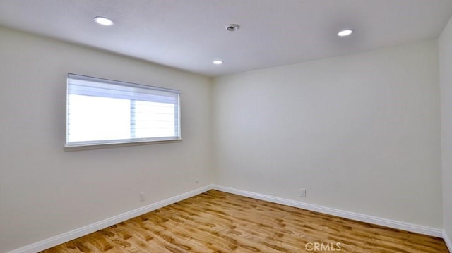 unfurnished room featuring hardwood / wood-style flooring