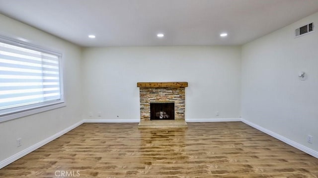 unfurnished living room with a fireplace and light hardwood / wood-style flooring