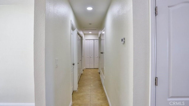 hall featuring light tile patterned flooring