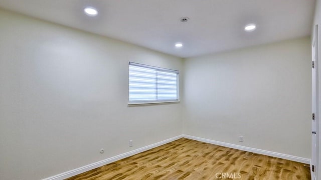 empty room with hardwood / wood-style flooring