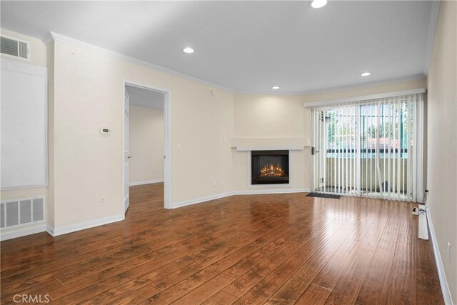 unfurnished living room with crown molding and dark hardwood / wood-style floors