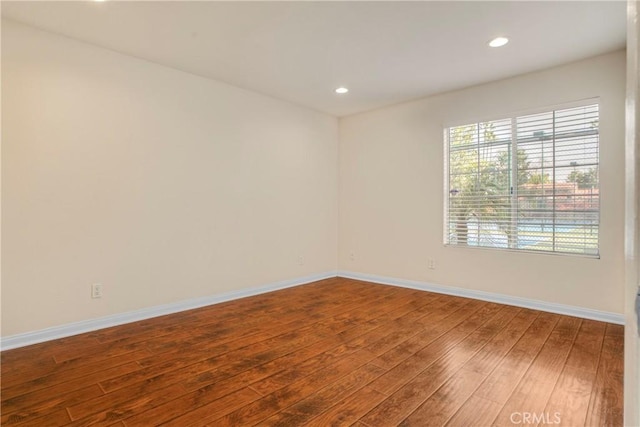 empty room with hardwood / wood-style flooring