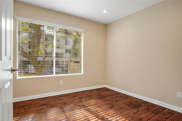 unfurnished room featuring dark wood-type flooring