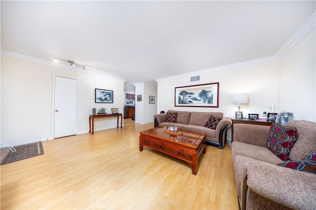 living room featuring crown molding and hardwood / wood-style flooring