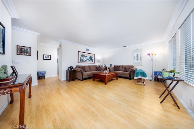 living room featuring crown molding and light hardwood / wood-style floors