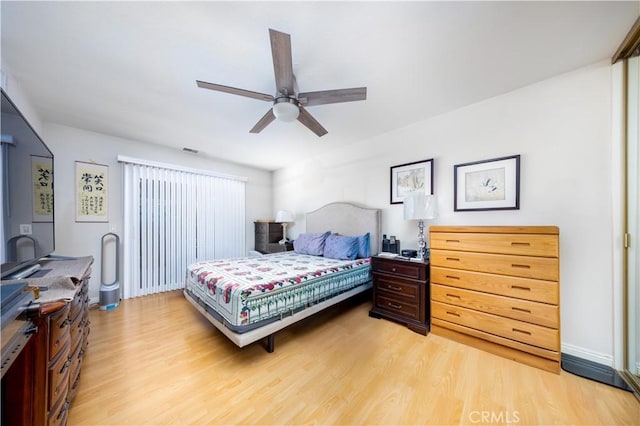 bedroom with light hardwood / wood-style flooring and ceiling fan