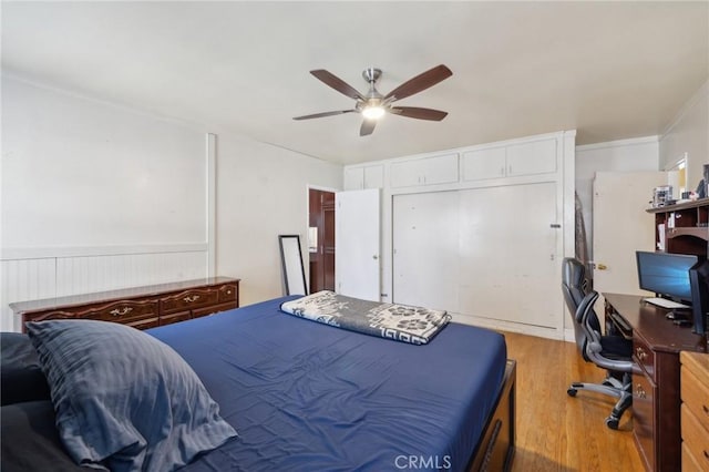 bedroom with a closet, ceiling fan, and light wood-type flooring