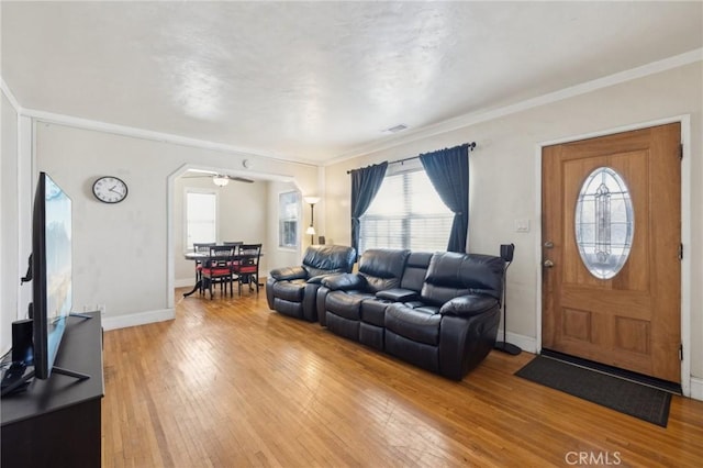 living room with crown molding and wood-type flooring