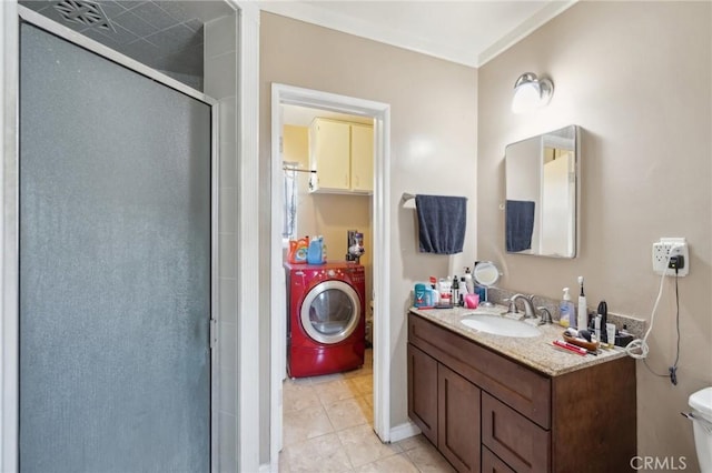 bathroom with washer and dryer, tile patterned flooring, vanity, an enclosed shower, and toilet