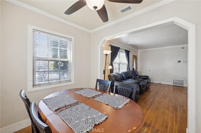 dining room featuring hardwood / wood-style floors, crown molding, and ceiling fan