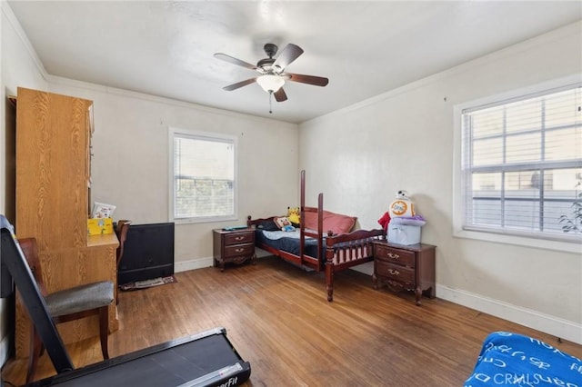 bedroom with hardwood / wood-style flooring, ceiling fan, and crown molding