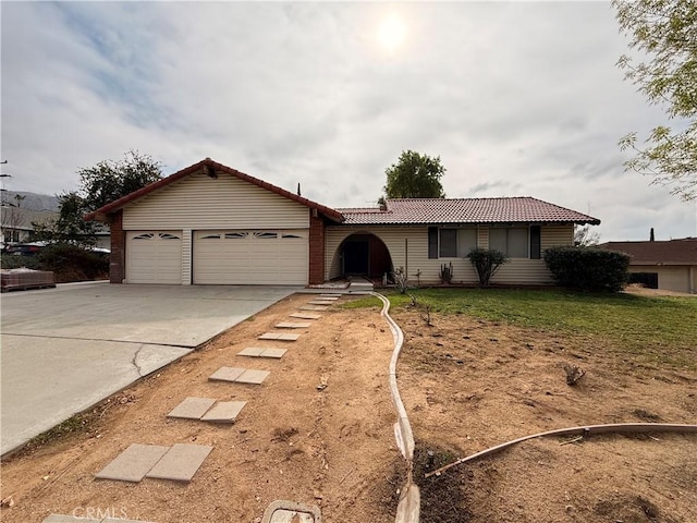 ranch-style home featuring a garage and a front lawn