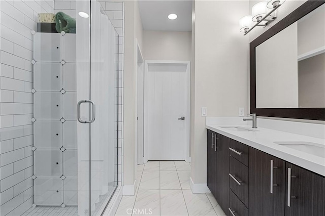 bathroom with a shower with door and vanity