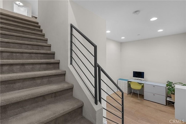 staircase with hardwood / wood-style floors