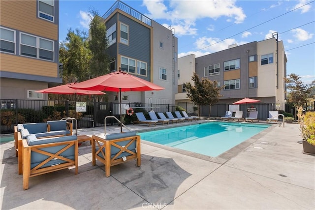 view of pool with an outdoor living space and a patio area