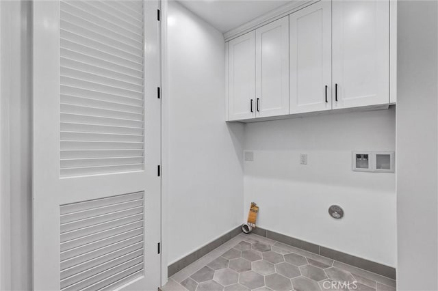 laundry area featuring cabinets, light tile patterned flooring, electric dryer hookup, and hookup for a washing machine