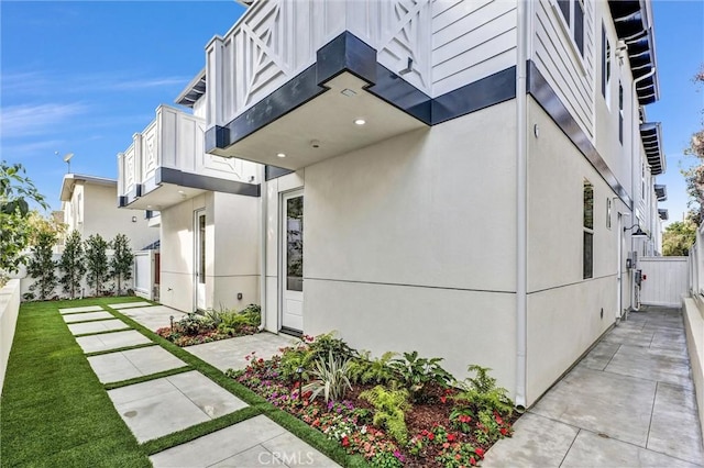 view of side of home with a balcony and a patio