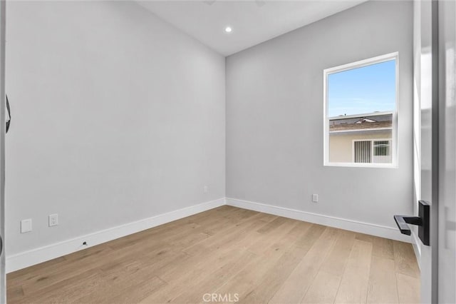 empty room with light hardwood / wood-style flooring