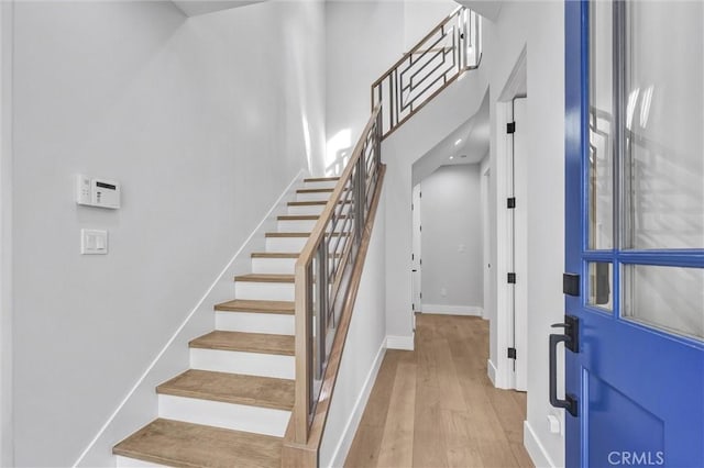 stairs featuring hardwood / wood-style floors