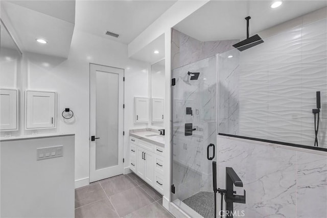 bathroom with walk in shower and vanity