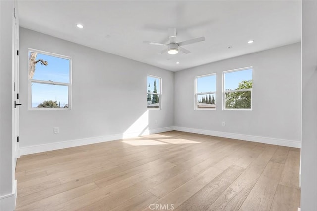 spare room featuring ceiling fan and light wood-type flooring