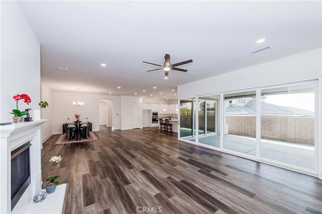 12430 Altura Dr, Rancho Cucamonga, CA 91739 - unfurnished living room featuring ceiling fan with notable chandelier and dark hardwood / wood-style floors