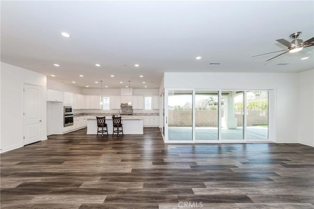 12430 Altura Dr, Rancho Cucamonga, CA 91739 - unfurnished living room featuring dark wood-type flooring and ceiling fan