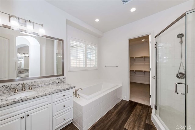 12430 Altura Dr, Rancho Cucamonga, CA 91739 - bathroom with vanity, separate shower and tub, and hardwood / wood-style floors
