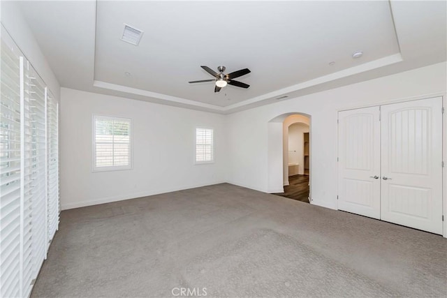 12430 Altura Dr, Rancho Cucamonga, CA 91739 - unfurnished bedroom featuring ceiling fan, a closet, dark carpet, and a tray ceiling