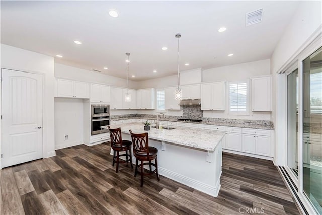 12430 Altura Dr, Rancho Cucamonga, CA 91739 - kitchen featuring white cabinetry, stainless steel appliances, and an island with sink