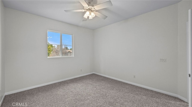 spare room featuring ceiling fan and carpet flooring