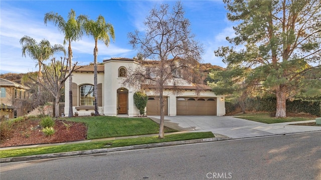 mediterranean / spanish-style house with a garage and a front lawn